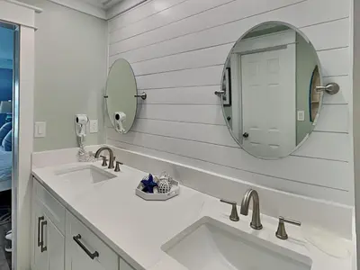 a bathroom with two sinks and a mirror at Edgewater Villa #909 in Panama City Beach