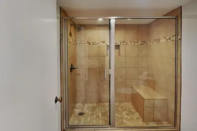 a shower with a glass door in a bathroom at Edgewater Tower II #606 in Panama City Beach