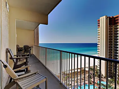 a balcony with chairs and the ocean in the background at Shores of Panama #1423 in Panama City Beach