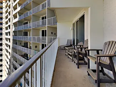 a row of chairs sitting on the balcony of a building at Shores of Panama #1423 in Panama City Beach