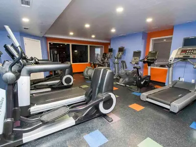 a gym with several treadmills and elliptical machines at Shores of Panama #1423 in Panama City Beach