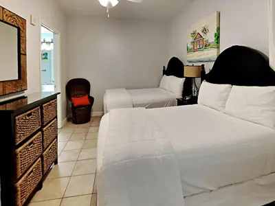 a bedroom with a white bed and a couch at Shores of Panama #1423 in Panama City Beach