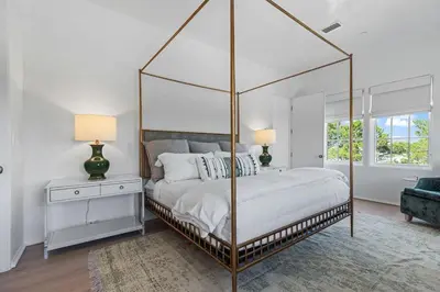 a bedroom with a large canopy bed and a couch at Oceanview Oasis in Seagrove Beach