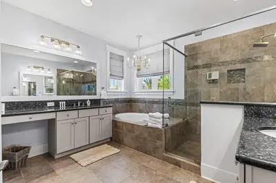 a bathroom with a tub and a shower and a sink at Gone Coastal in Santa Rosa Beach