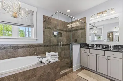 a bathroom with a tub and a sink and a mirror at Gone Coastal in Santa Rosa Beach