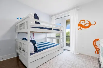 a white bedroom with a bunk bed and a window at Gone Coastal in Santa Rosa Beach