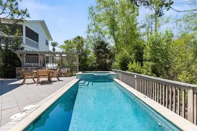 a swimming pool in front of a house with a patio at Gone Coastal in Santa Rosa Beach