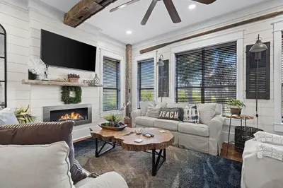 a living room with a couch and a fireplace at Let It Be in Inlet Beach