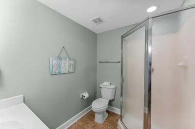 a bathroom with a toilet and a shower at Stunning 3BR Corner Tidewater Resort Beachfront Condo! Sleeps 10! by Dolce Vita Getaways PCB! in Panama City Beach