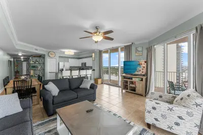 a living room with a couch and a table at Stunning 3BR Corner Tidewater Resort Beachfront Condo! Sleeps 10! by Dolce Vita Getaways PCB! in Panama City Beach