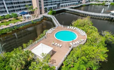 an overhead view of a swimming pool in a river at Family and Friends Beach Resort Condo for 8! Steps from the Beach! By Dolce Vita Getaways! in Panama City Beach