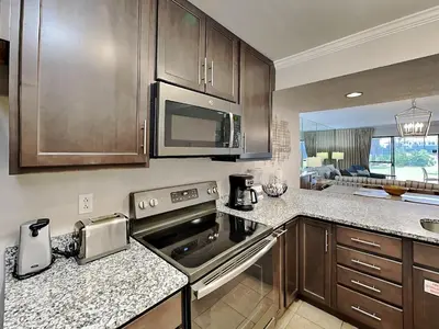 a kitchen with a stove and a microwave at Edgewater Villa #2601 in Panama City Beach