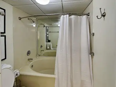 a bathroom with a tub and a shower curtain at Edgewater Villa #2601 in Panama City Beach