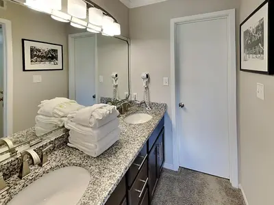 a bathroom with two sinks and a large mirror at Edgewater Villa #2601 in Panama City Beach