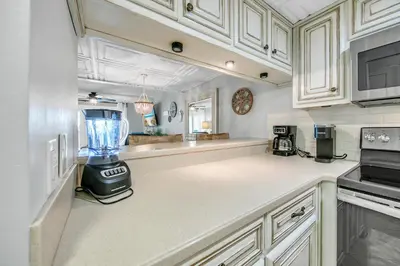 a kitchen with a blender in the middle of it at Sugar Beach Condo B-14 by Emerald Coast Retreats in Panama City Beach