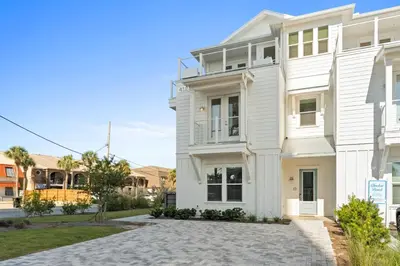 a white house with a driveway in front of it at Take It Easy by Book That Condo in Panama City Beach