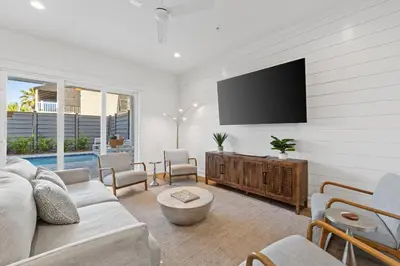 a living room with a couch and a tv at Take It Easy by Book That Condo in Panama City Beach