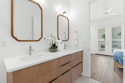 a bathroom with two sinks and two mirrors at Take It Easy by Book That Condo in Panama City Beach