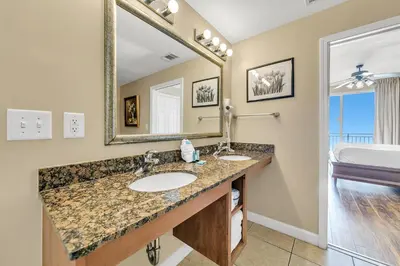 a bathroom with two sinks and a large mirror at Splash 507E in Panama City Beach