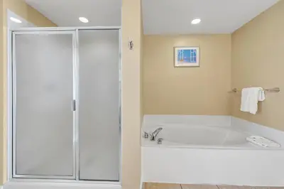 a large bathroom with a tub and a shower at Splash 507E in Panama City Beach