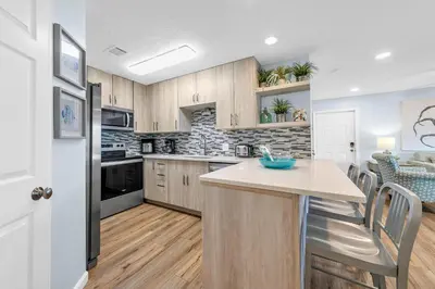 a kitchen with wooden cabinets and a counter top at Beachside Villas 832 in Santa Rosa Beach