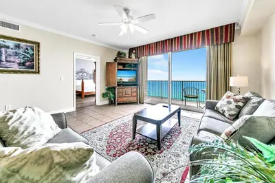 a living room with two couches and a tv at Tidewater 1902 in Panama City Beach