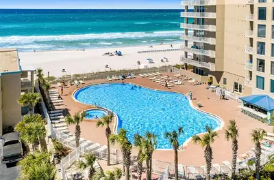 an overhead view of a swimming pool and the beach at Tidewater 1902 in Panama City Beach