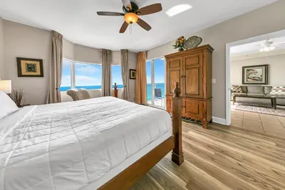 a bedroom with a bed and a ceiling fan at Tidewater 1902 in Panama City Beach