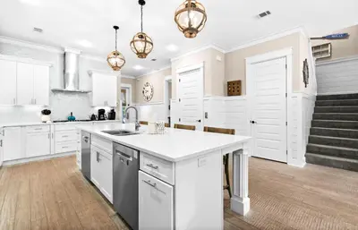 a kitchen with white cabinets and a white counter top at Forever Five O'Clock in Seacrest