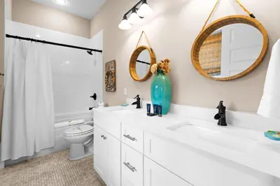 a bathroom with a sink and a toilet and a mirror at Forever Five O'Clock in Seacrest