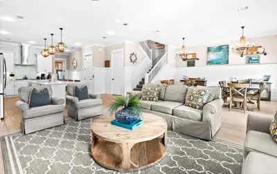 a living room with a couch and a table at Forever Five O'Clock in Seacrest