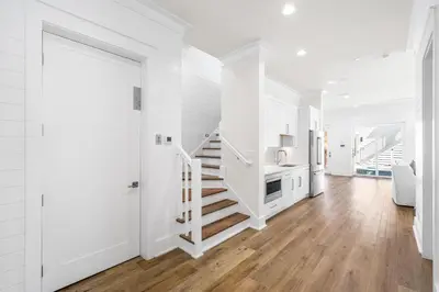 a white hallway with white walls and a white staircase at 30A Sunrise 6 Bedroom in Santa Rosa Beach