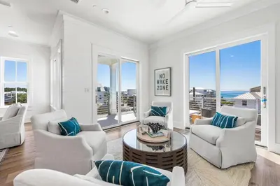 a living room with white furniture and large windows at 30A Sunrise 6 Bedroom in Santa Rosa Beach
