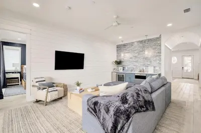 a living room with a couch and a tv at Sunset Serenity in Panama City Beach