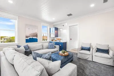 a living room with a couch and two chairs at Sunset Serenity in Panama City Beach