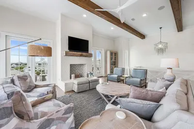 a living room with a couch and a fireplace at Stars on the Water in Santa Rosa Beach