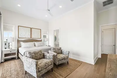 a bedroom with a bed and a couch and a chair at Stars on the Water in Santa Rosa Beach