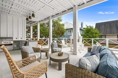 a patio with a couch and chairs and a table at Stars on the Water in Santa Rosa Beach