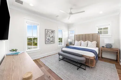 a white bedroom with a large bed and windows at 30A Sunset 6 Bedroom in Santa Rosa Beach