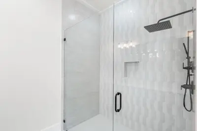 a shower with a glass door in a bathroom at 30A Sunset 6 Bedroom in Santa Rosa Beach