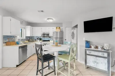 a kitchen with a table and chairs in a kitchen at Sand Castles West B28 (1/1) in Panama City Beach