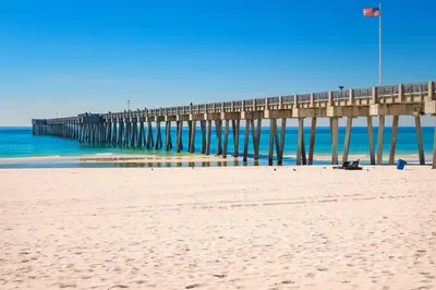 a pier on the beach next to the ocean at Sand Castles West B28 (1/1) in Panama City Beach