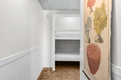 a hallway with a door to a closet with vegetables on it at Moondrifter #803 in Panama City Beach