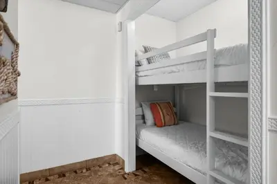 a white bunk bed in a white room at Moondrifter #803 in Panama City Beach
