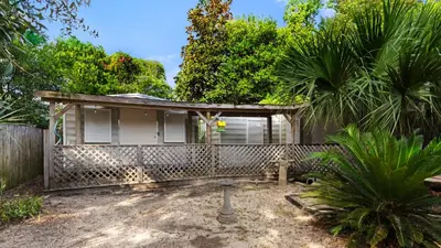 an old house with a palm tree in the yard at Vintage Waves in Laguna Beach