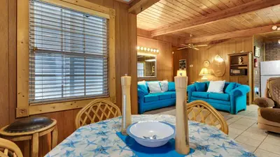 a dining room with a table and chairs and a living room at Vintage Waves in Laguna Beach