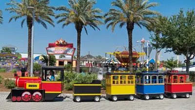 a train ride in a park with palm trees at Vintage Waves in Laguna Beach