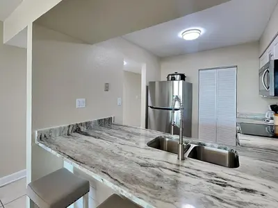 a kitchen with a sink and a counter top at Dunes of Panama #B203 in Panama City Beach