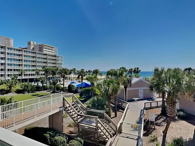 a view of the beach from the balcony of a resort at Dunes of Panama #B203 in Panama City Beach
