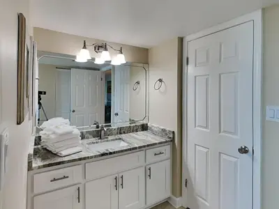 a bathroom with a sink and a mirror at Dunes of Panama #B203 in Panama City Beach
